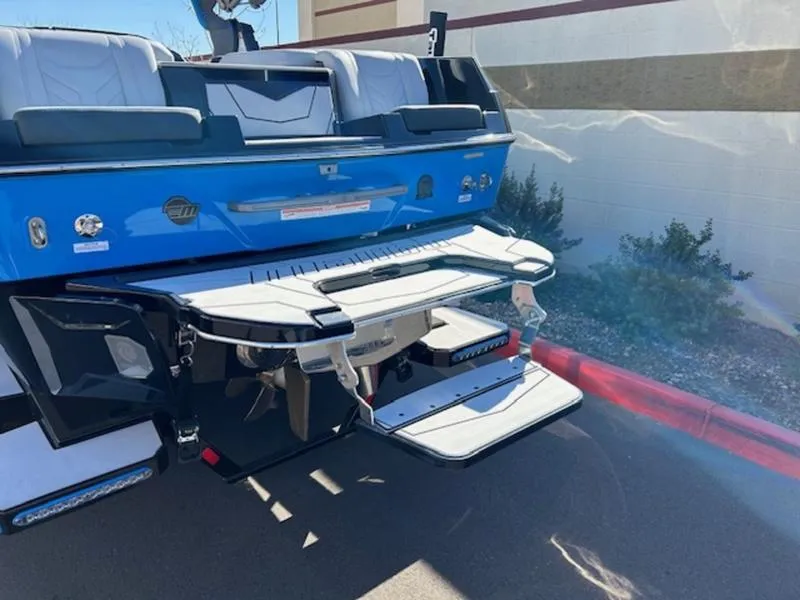 Slide: The Image of 2025 Malibu 25 LSV boat rear view with swim platform and seating. - 7