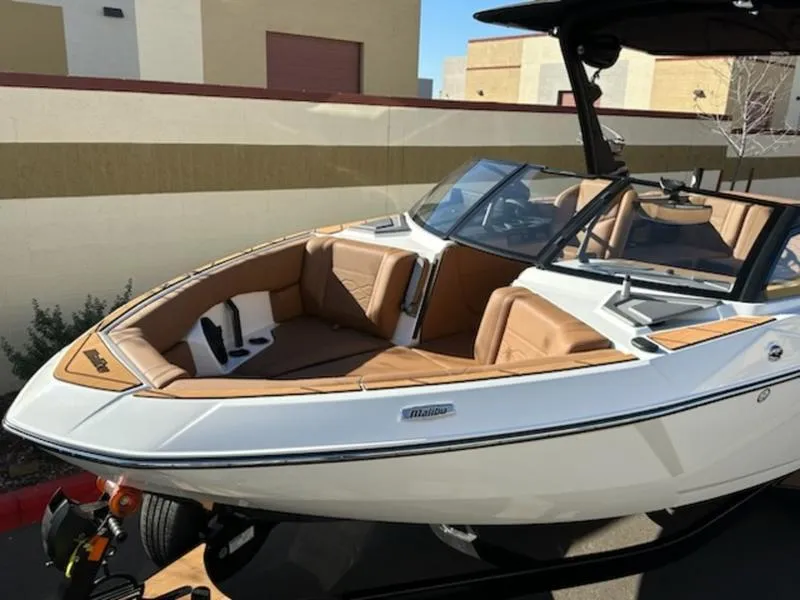 Slide: The Image of 2025 Malibu 22 LSV boat with tan interior and sleek design. - 10