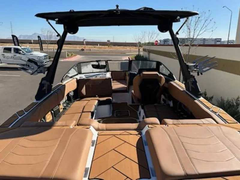 Slide: The Image of 2025 Malibu 22 LSV boat with luxurious tan interior and spacious seating. - 12