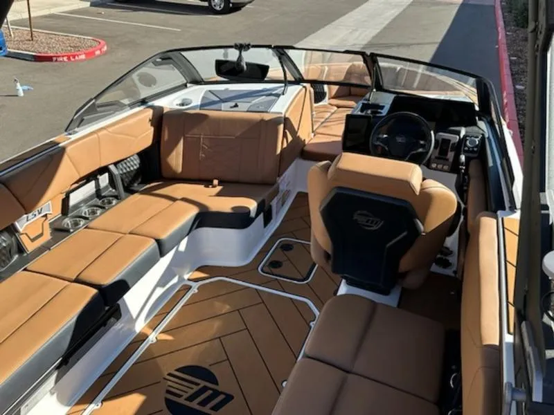 Slide: The Image of 2025 Malibu 22 LSV boat interior with tan leather seating and modern dashboard. - 15