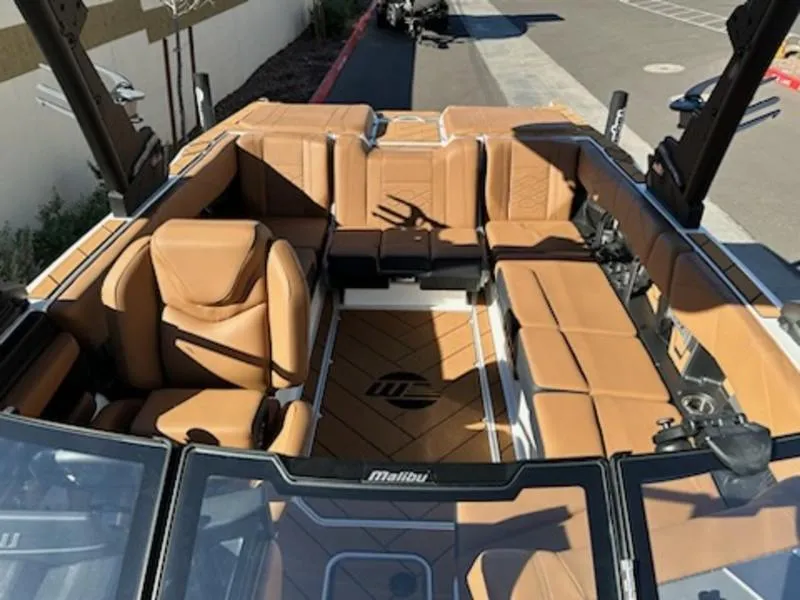 Slide: The Image of 2025 Malibu 22 LSV boat interior with tan leather seating. - 17