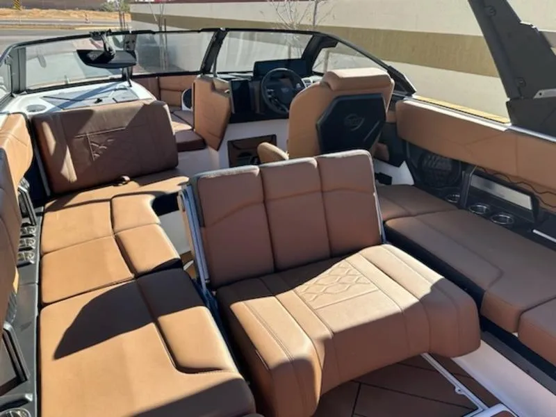 Slide: The Image of 2025 Malibu 22 LSV boat interior with luxurious brown leather seating. - 20