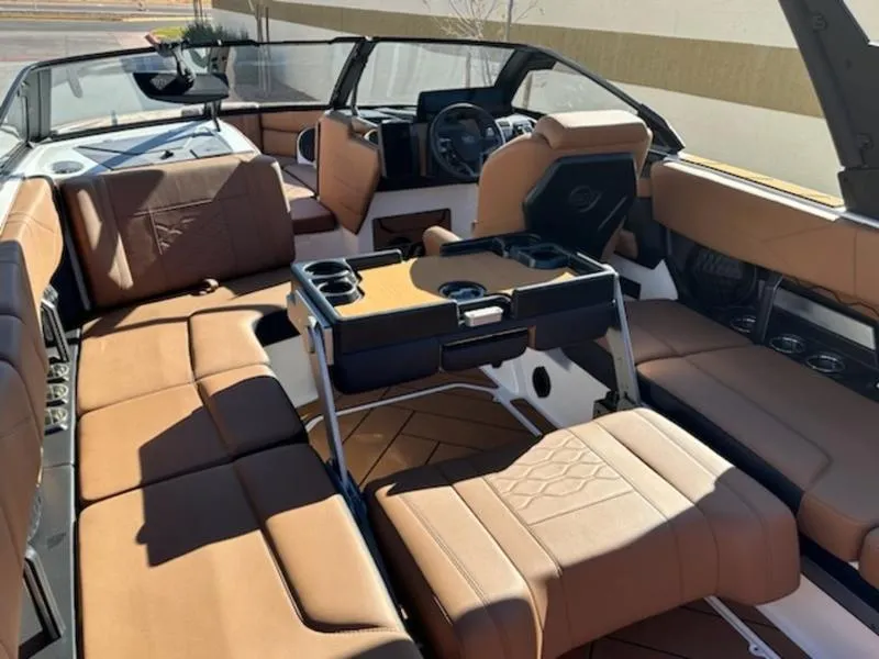 Slide: The Image of Luxurious interior of 2025 Malibu 22 LSV boat with brown leather seating. - 21