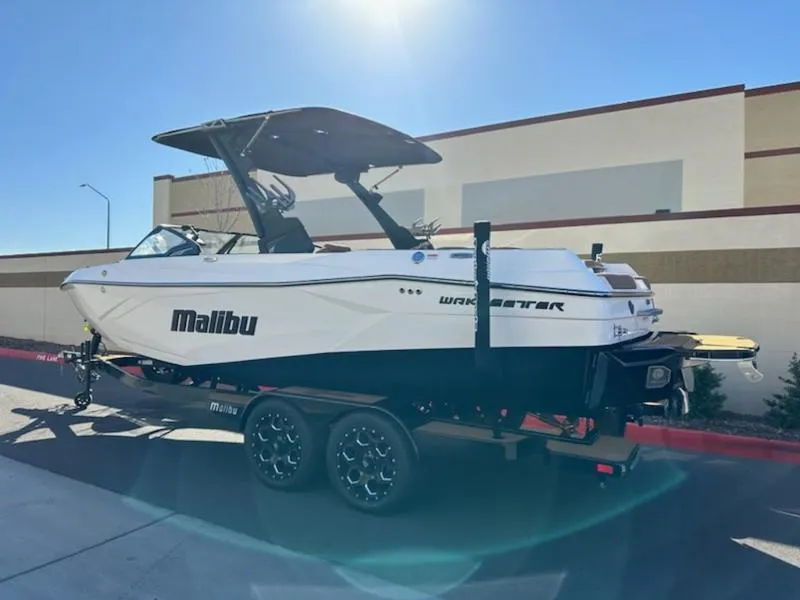 Slide: The Image of 2025 Malibu 22 LSV boat on trailer, parked outdoors in sunlight. - 5