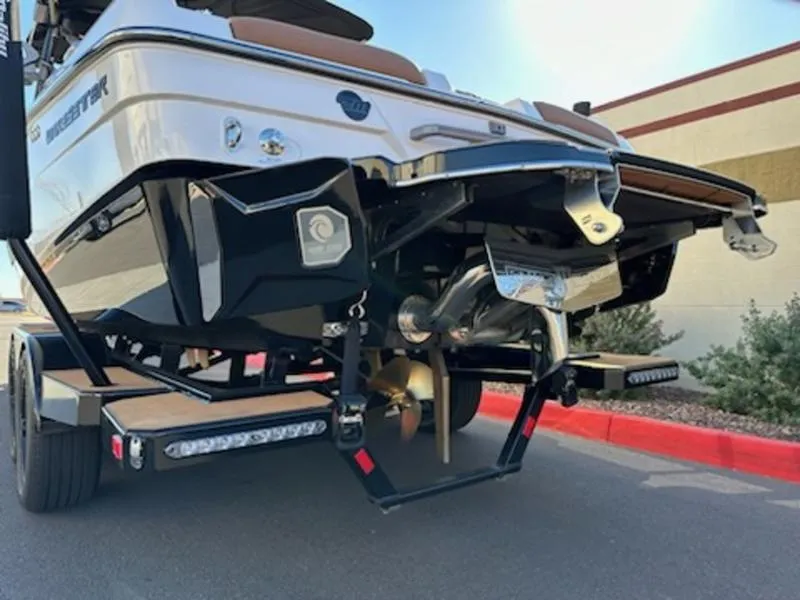 Slide: The Image of 2025 Malibu 22 LSV boat rear view, showcasing propeller and trailer details. - 6