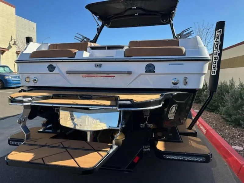 Slide: The Image of 2025 Malibu 22 LSV boat rear view with swim platform and seating. - 7