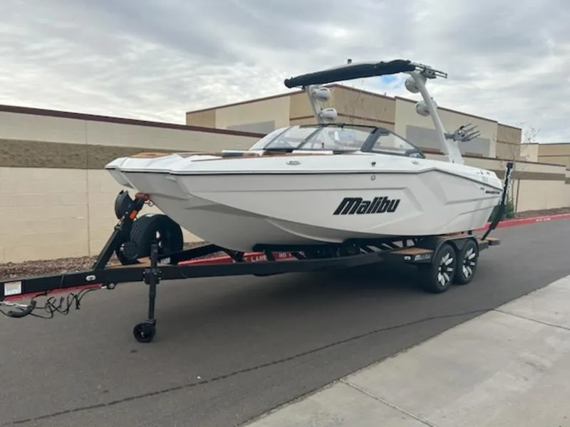 Slide: The Image of 2025 Malibu 22 MXZ boat on trailer, parked on street. - 10