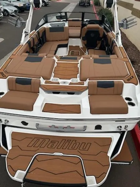 Slide: The Image of 2025 Malibu 22 MXZ boat with luxurious tan seating and sleek design. - 3