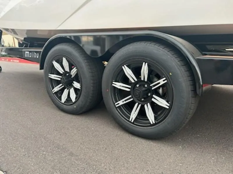 Slide: The Image of 2025 Malibu 22 MXZ trailer with stylish black and white wheels. - 7
