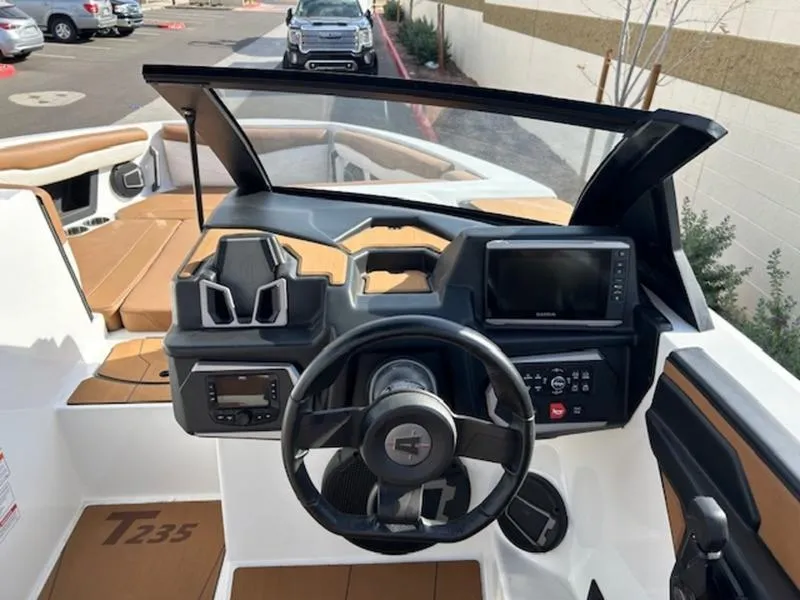 Slide: The Image of 2024 Axis T235 boat dashboard with steering wheel and navigation system. - 15