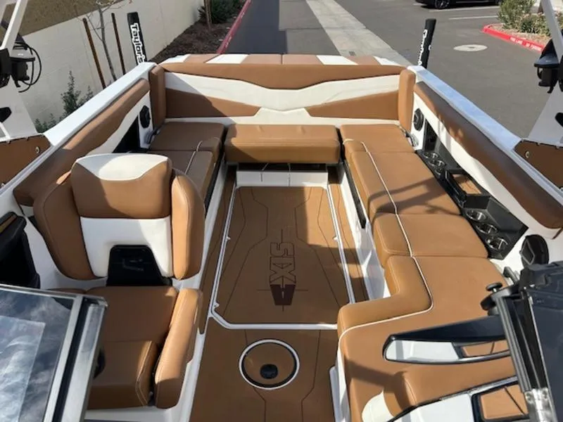 Slide: The Image of 2024 Axis T235 boat interior with tan and white seating, spacious layout, and modern design. - 20