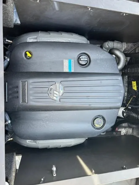 Slide: The Image of 2024 Axis T235 engine compartment with visible components and branding. - 3