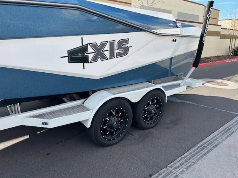 Slide: The Image of 2024 Axis T235 boat on trailer, featuring sleek design and dual axles. - 4