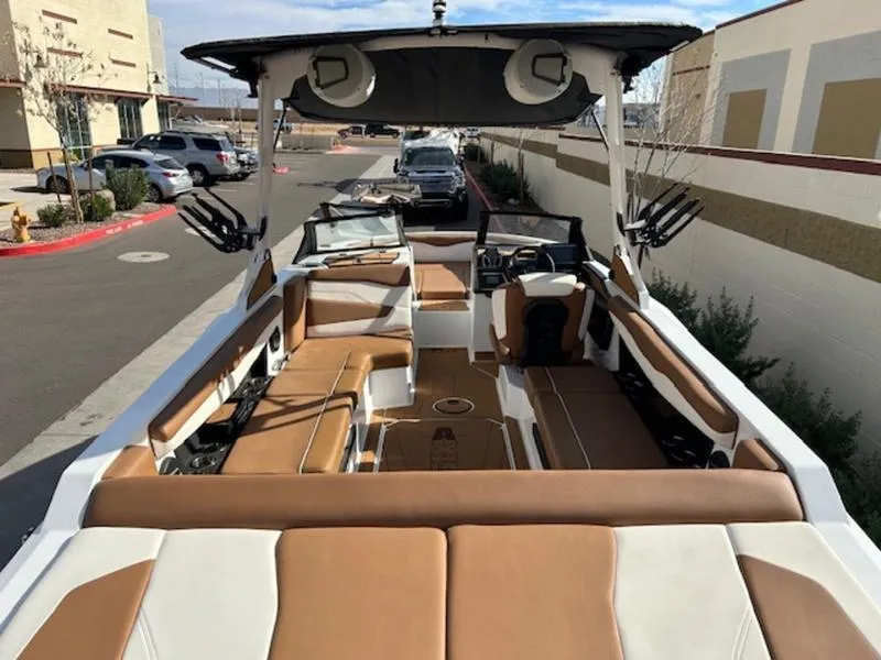 Slide: The Image of 2024 Axis T235 boat with spacious seating and modern design in a parking lot. - 9