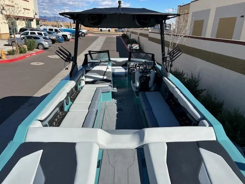 Slide: The Image of 2024 Axis T250 boat with spacious seating and modern design in a parking area. - 10