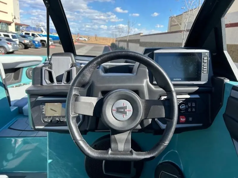 Slide: The Image of 2024 Axis T250 boat dashboard with steering wheel and digital displays. - 13