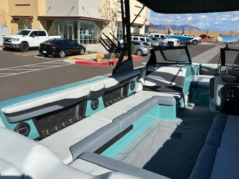 Slide: The Image of 2024 Axis T250 boat interior with spacious seating in a parking lot. - 16