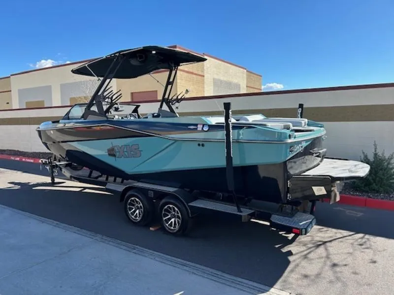 Slide: The Image of 2024 Axis T250 boat on trailer, parked outdoors under clear sky. - 4