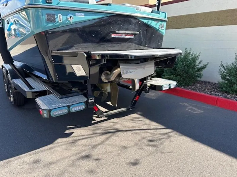 Slide: The Image of 2024 Axis T250 boat rear view with trailer, parked on a street. - 5