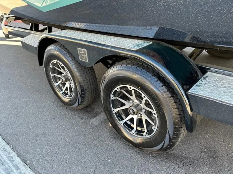 Slide: The Image of 2024 Axis T250 trailer with dual black alloy wheels on asphalt. - 7