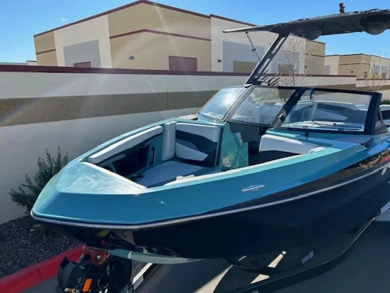 Slide: The Image of 2024 Axis T250 boat with sleek design, parked outdoors. - 9