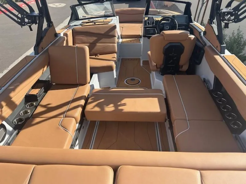 Slide: The Image of Luxurious interior of 2025 Axis A225 boat with tan leather seating and modern dashboard. - 11