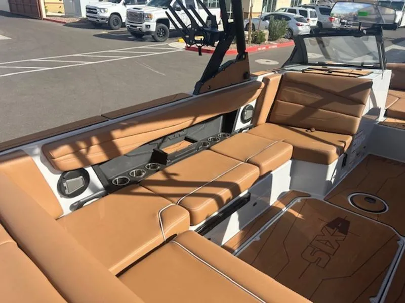 Slide: The Image of 2025 Axis A225 boat interior with tan leather seating and modern design. - 12