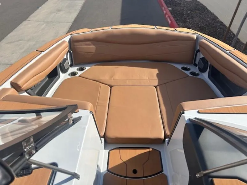 Slide: The Image of 2025 Axis A225 boat interior with tan leather seating and cup holders. - 15