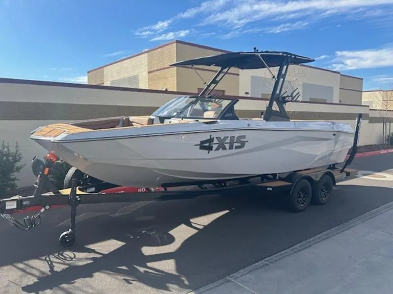 Slide: The Image of 2025 Axis A225 boat on trailer, parked outdoors under clear sky. - 3