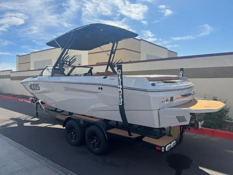 Slide: The Image of 2025 Axis A225 boat on trailer, parked outdoors under a clear sky. - 4