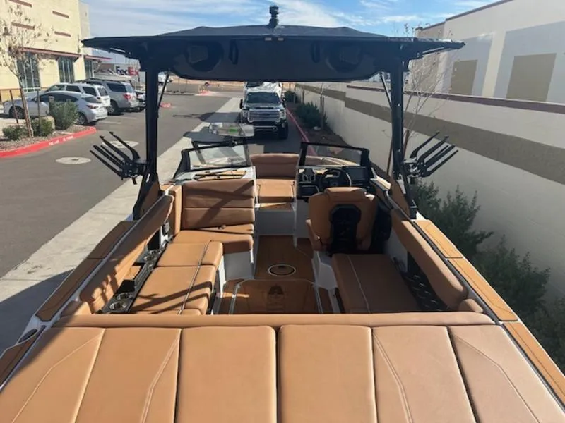 Slide: The Image of 2025 Axis A225 boat with tan interior, parked outdoors. - 9