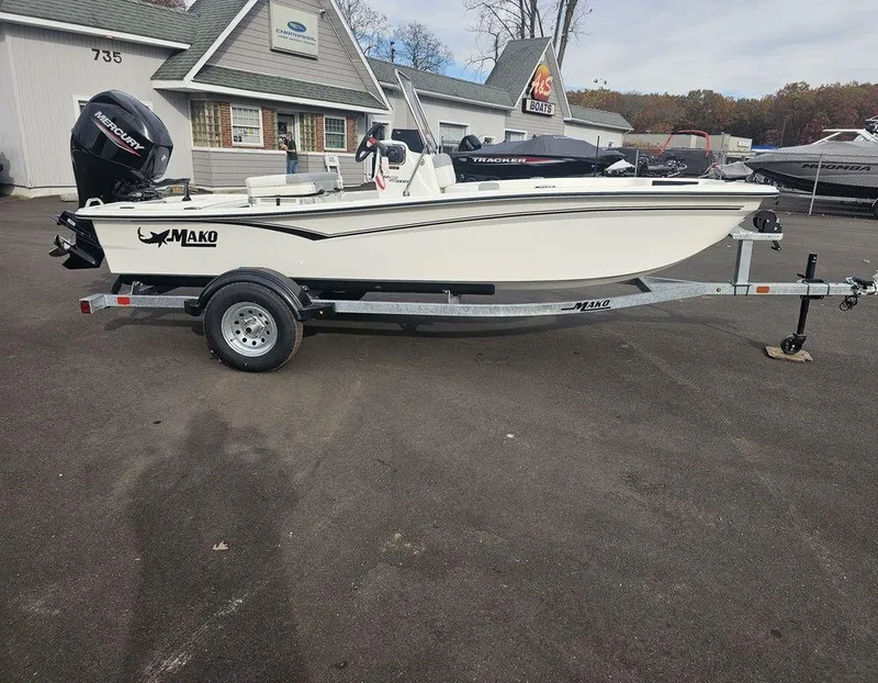 The Image of 2025 Mako Pro Skiff 15 CC boat on trailer in dealership lot. - 1