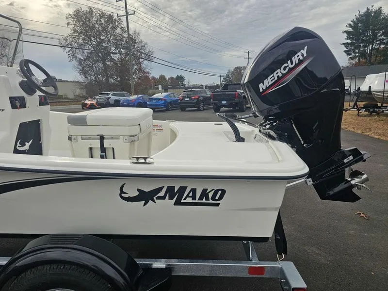 Slide: The Image of 2025 Mako Pro Skiff 15 CC with Mercury outboard motor on trailer. - 11