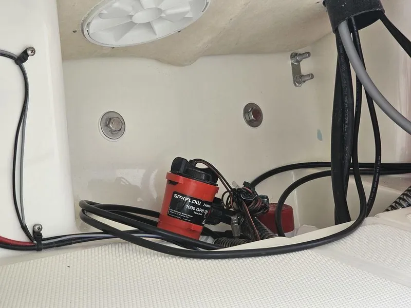 Slide: The Image of 2025 Mako Pro Skiff 15 CC bilge area with wiring and pump. - 12