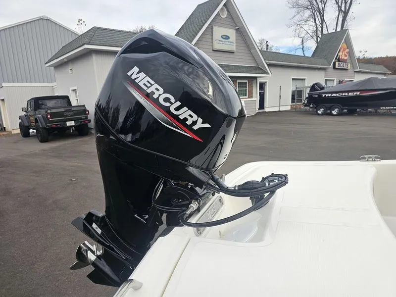 Slide: The Image of 2025 Mako Pro Skiff 15 CC with Mercury outboard motor in a dealership lot. - 13