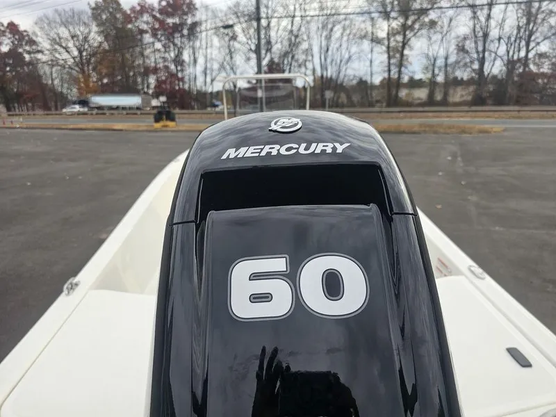 Slide: The Image of 2025 Mako Pro Skiff 15 CC with Mercury 60 horsepower engine in parking lot. - 19