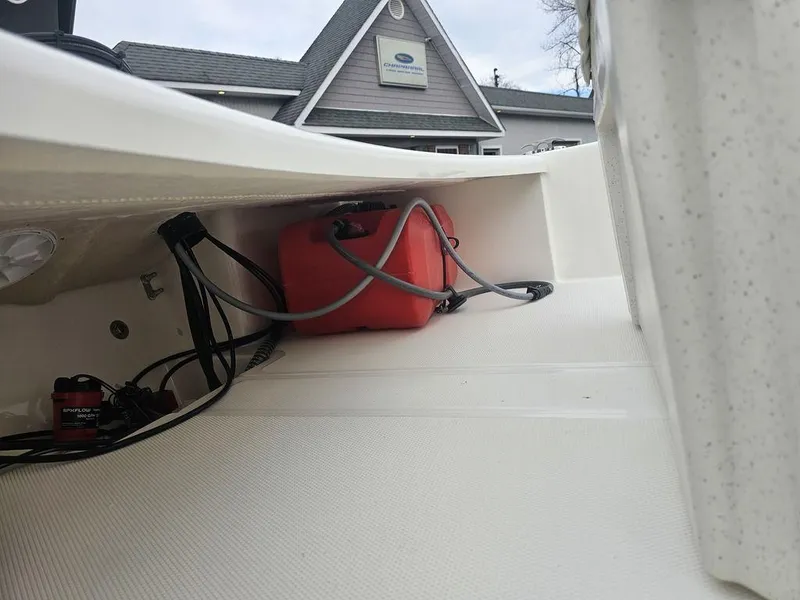 Slide: The Image of 2025 Mako Pro Skiff 15 CC interior with red fuel tank and wiring. - 24