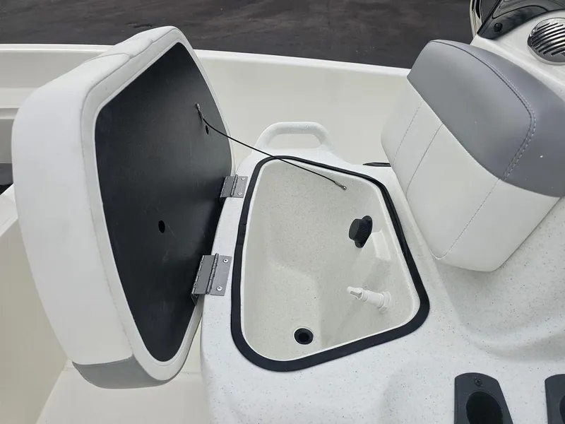 Slide: The Image of 2025 Mako Pro Skiff 15 CC boat storage compartment with open lid and seating. - 27