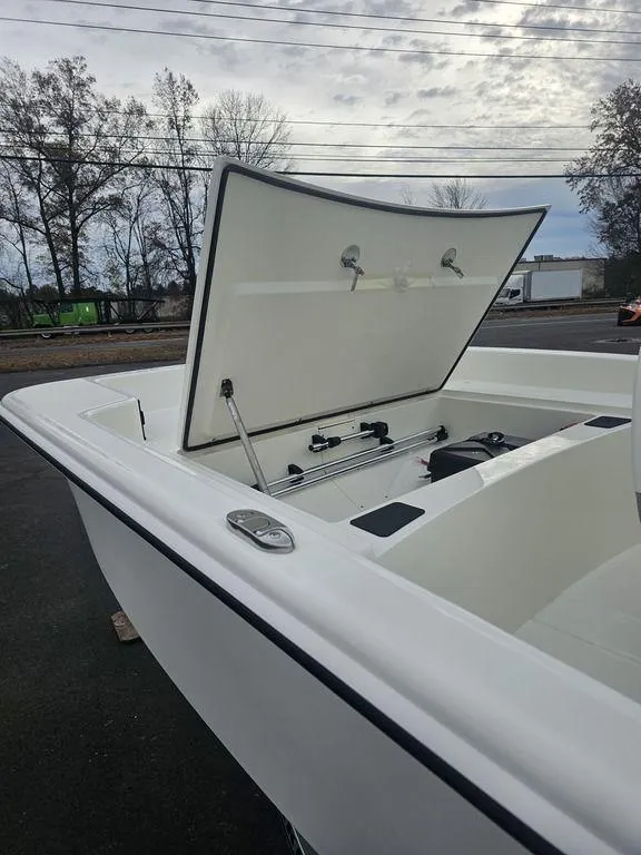 Slide: The Image of 2025 Mako Pro Skiff 15 CC boat with open storage compartment. - 30