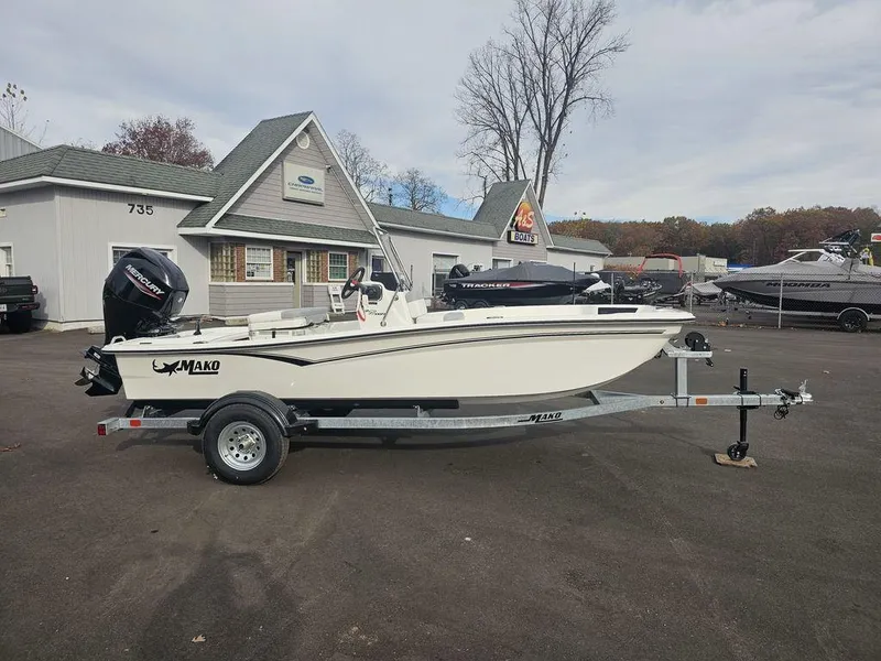 Slide: The Image of 2025 Mako Pro Skiff 15 CC boat on trailer, parked outside dealership. - 5