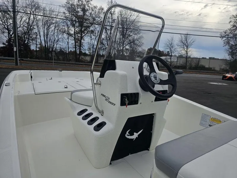 Slide: The Image of 2025 Mako Pro Skiff 15 CC boat interior with steering console and seating. - 9