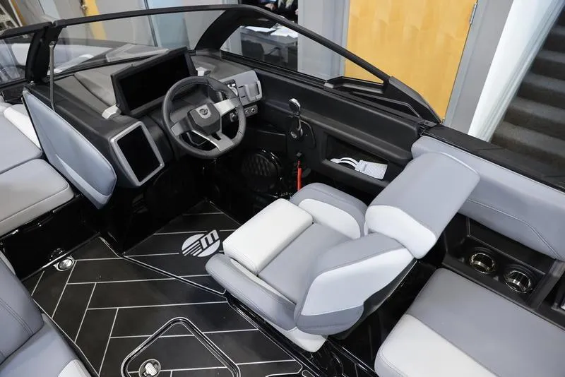 Slide: The Image of 2024 Malibu 22 LSV boat interior with modern dashboard and seating. - 11