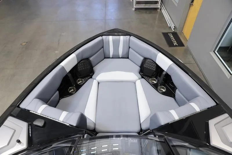 Slide: The Image of 2024 Malibu 22 LSV boat interior with gray seating and cup holders. - 14