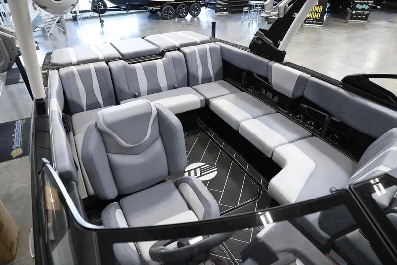Slide: The Image of 2024 Malibu 22 LSV boat interior with sleek gray seating and modern design. - 17