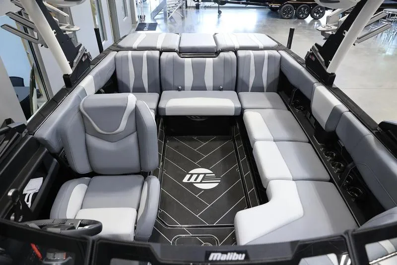 Slide: The Image of 2024 Malibu 22 LSV boat interior with gray seating and sleek design. - 18