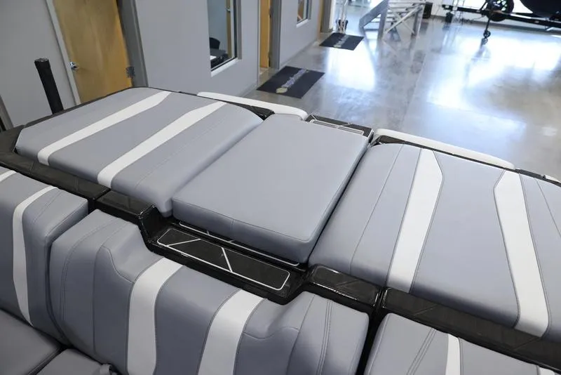 Slide: The Image of 2024 Malibu 22 LSV boat interior with sleek gray and white seating. - 20
