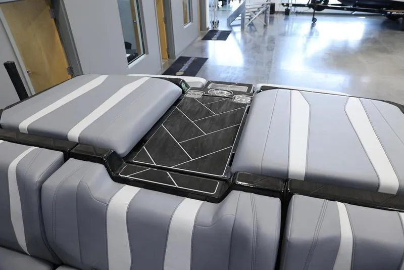 Slide: The Image of 2024 Malibu 22 LSV boat interior with sleek gray and white seating design. - 21