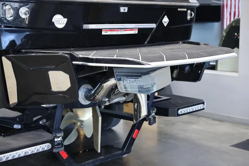 Slide: The Image of 2024 Malibu 22 LSV boat rear view with propeller and swim platform. - 5