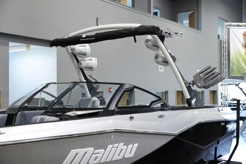 Slide: The Image of 2024 Malibu 22 LSV boat with sleek design and advanced features in showroom. - 6