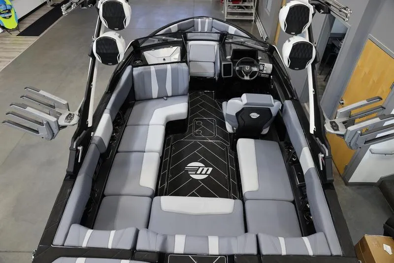 Slide: The Image of 2024 Malibu 22 LSV boat interior with sleek seating and modern design. - 9